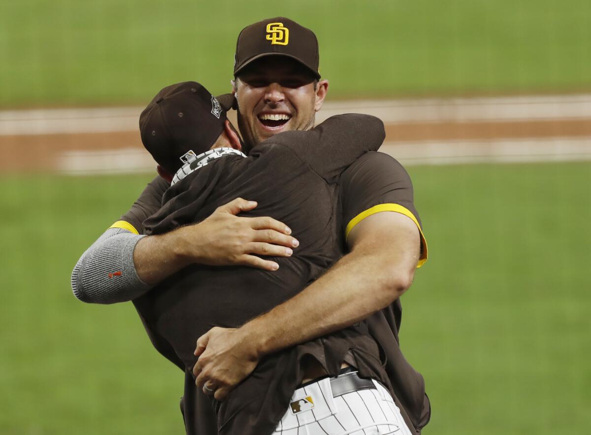Pitcher Craig Stammen and manager Jayce Tingler celebrate winning the NL Wild Card Series at Petco Park.