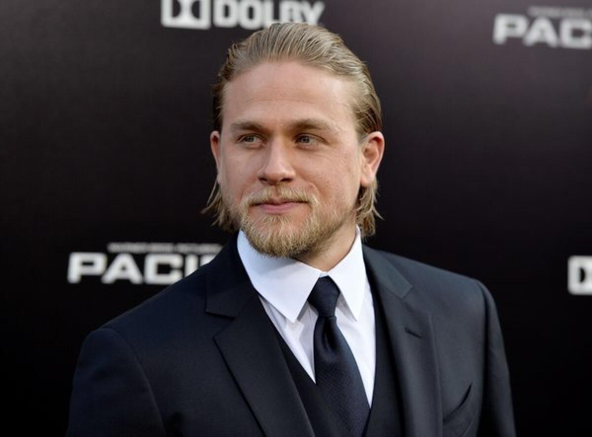 Actor Charlie Hunnam, shown arriving at the premiere of "Pacific Rim," has been cast as Christian Grey in the upcoming film "Fifty Shades of Grey." His casting is being protested by some fans of the racy novel.