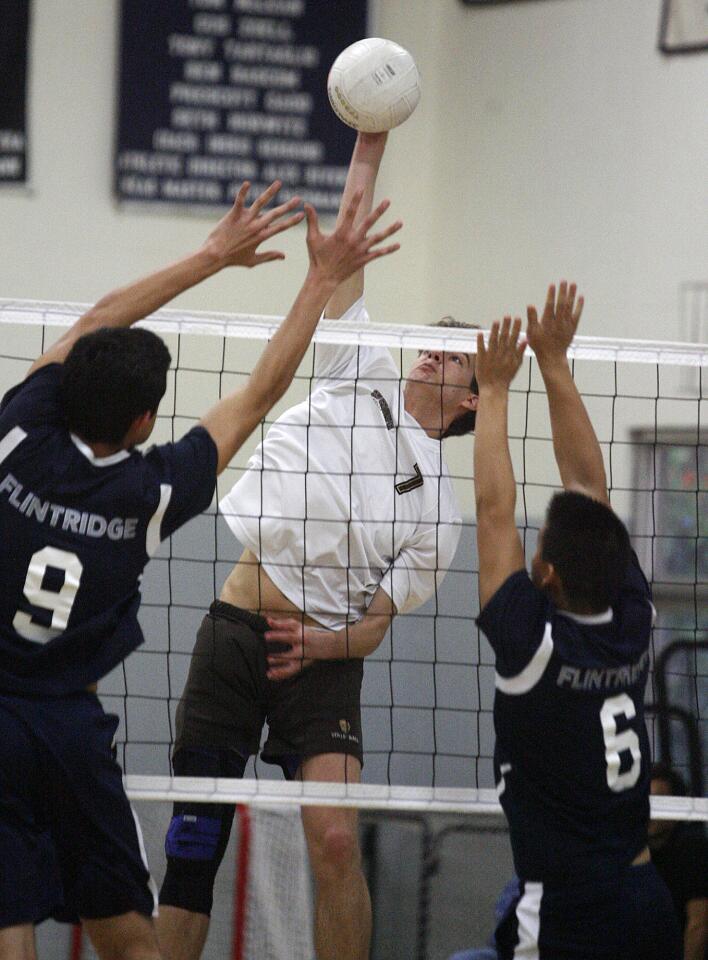 St. Francis' Charles McCarthy spikes a kill attempt against Flintridge Prep's Dante Fregoso and Mike Lii in a non-league boys volleyball match at Flintridge Prep in La Canada Flintridge on Monday, March 4, 2013.