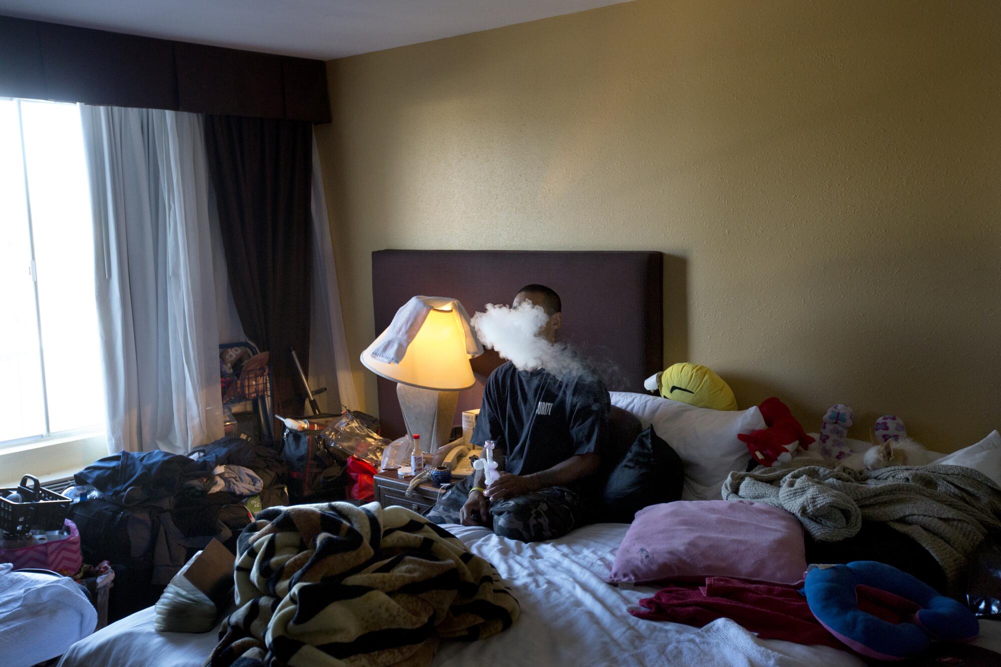 A man from a homeless encampment in Encino smokes crystal meth in his hotel room.