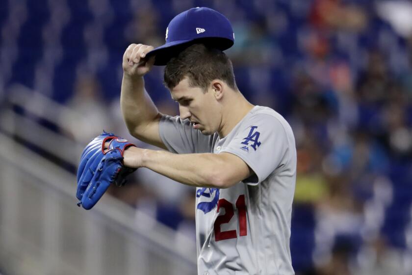 Los Angeles Dodgers starting pitcher Walker Buehler (21) adjusts his cap after walking Miami Marlins' Isan Diaz during the fourth inning of a baseball game, Thursday, Aug. 15, 2019, in Miami. (AP Photo/Lynne Sladky)