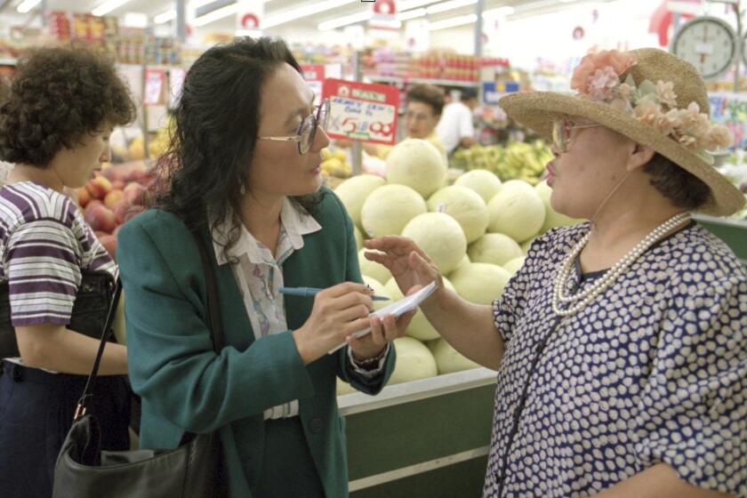 Times reporter K. Connie Kang talks to shopper in Koreatown about Kim Il Sung on 7/9/1994.
