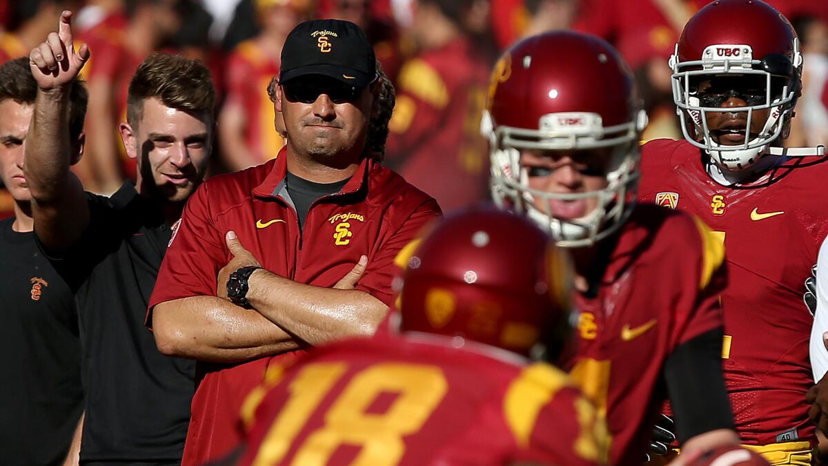 USC Coach Steve Sarkisian watches his players warm up before a game against Arizona State at the Coliseum on Oct. 4.