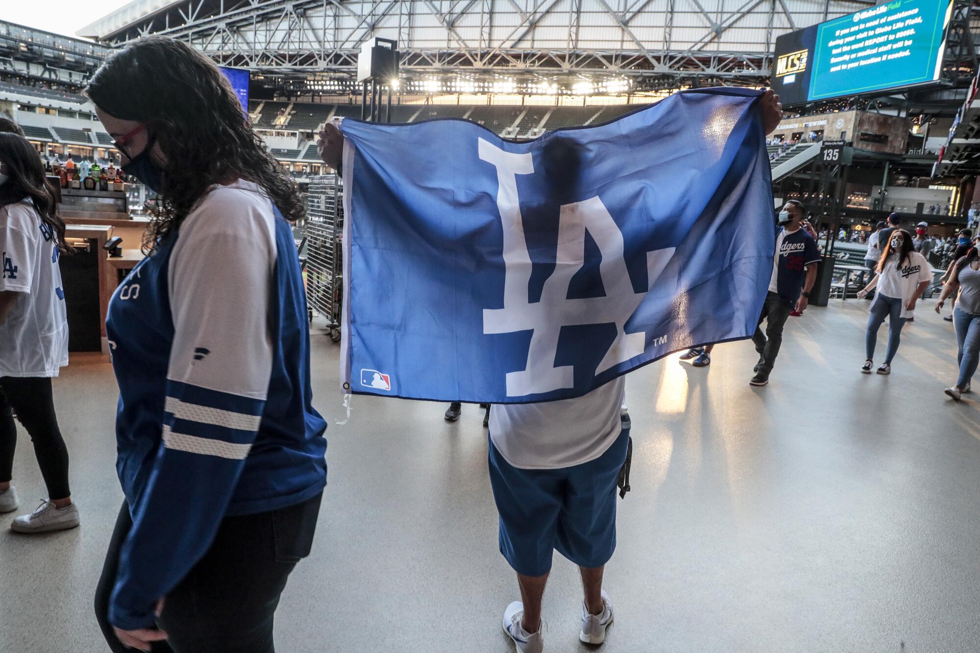 Emily and Robert Alvarez root on the Dodgers before the start of Game 1 of the NLCS.