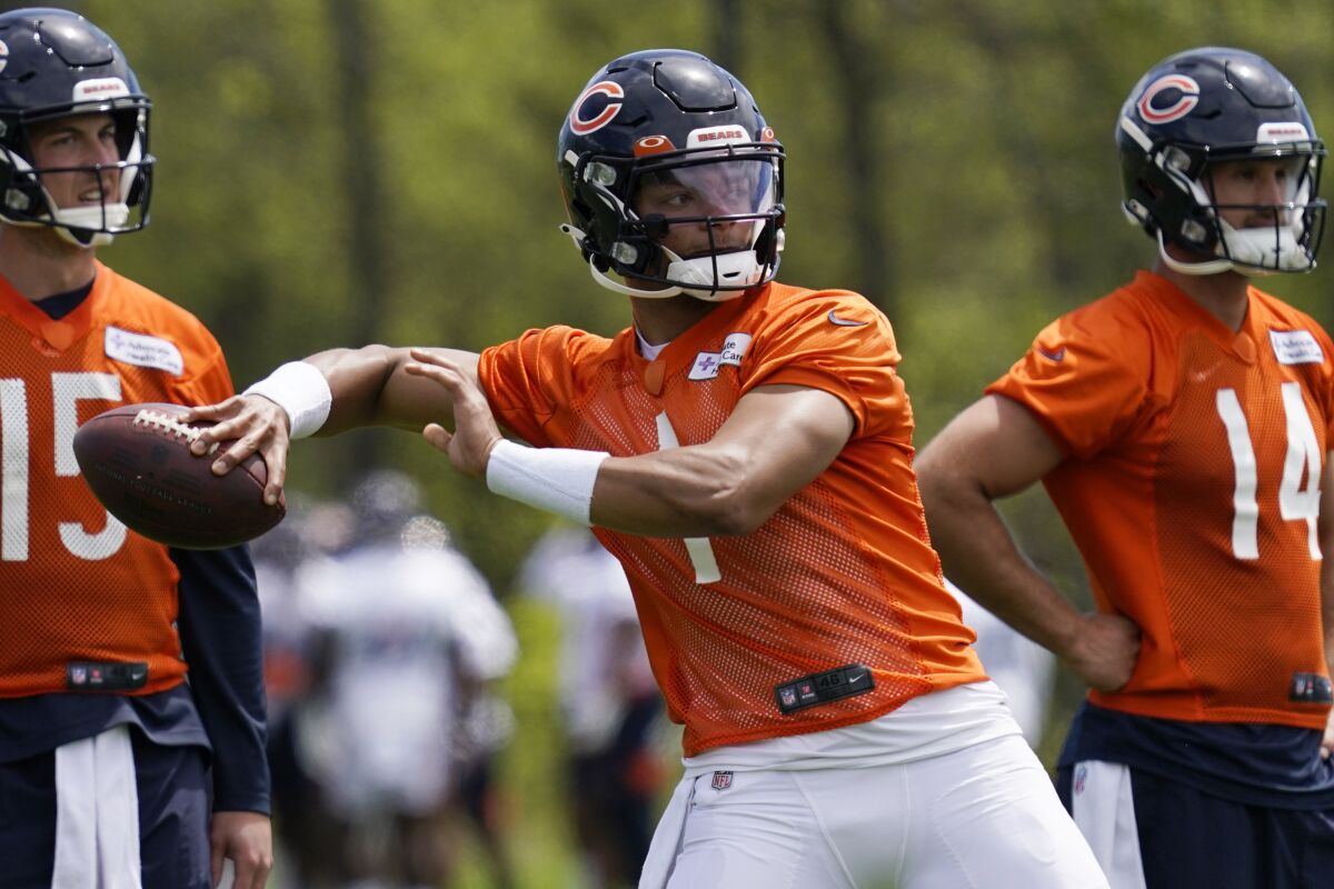 Chicago Bears quarterback Justin Fields throws a pass at the NFL football team's practice facility in Lake Forest, Ill., Wednesday, May 17, 2022. (AP Photo/Nam Y. Huh)