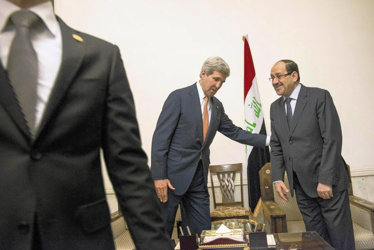 Iraqi Prime Minister Nouri Maliki and U.S. Secretary of State John Kerry meet in Baghdad on June 23.