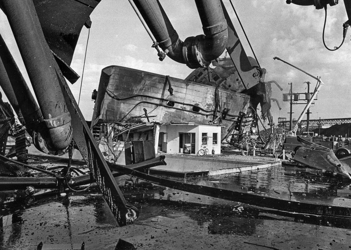 Dec. 18, 1976: Two men in a dockside shack that housed a computer control center apparently escaped unharmed when the superstructure of the Sansinena flew over the shack and landed behind it.