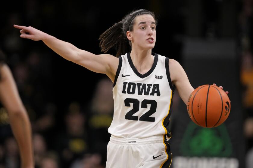Iowa guard Caitlin Clark (22) directs the team on offense during the second half.