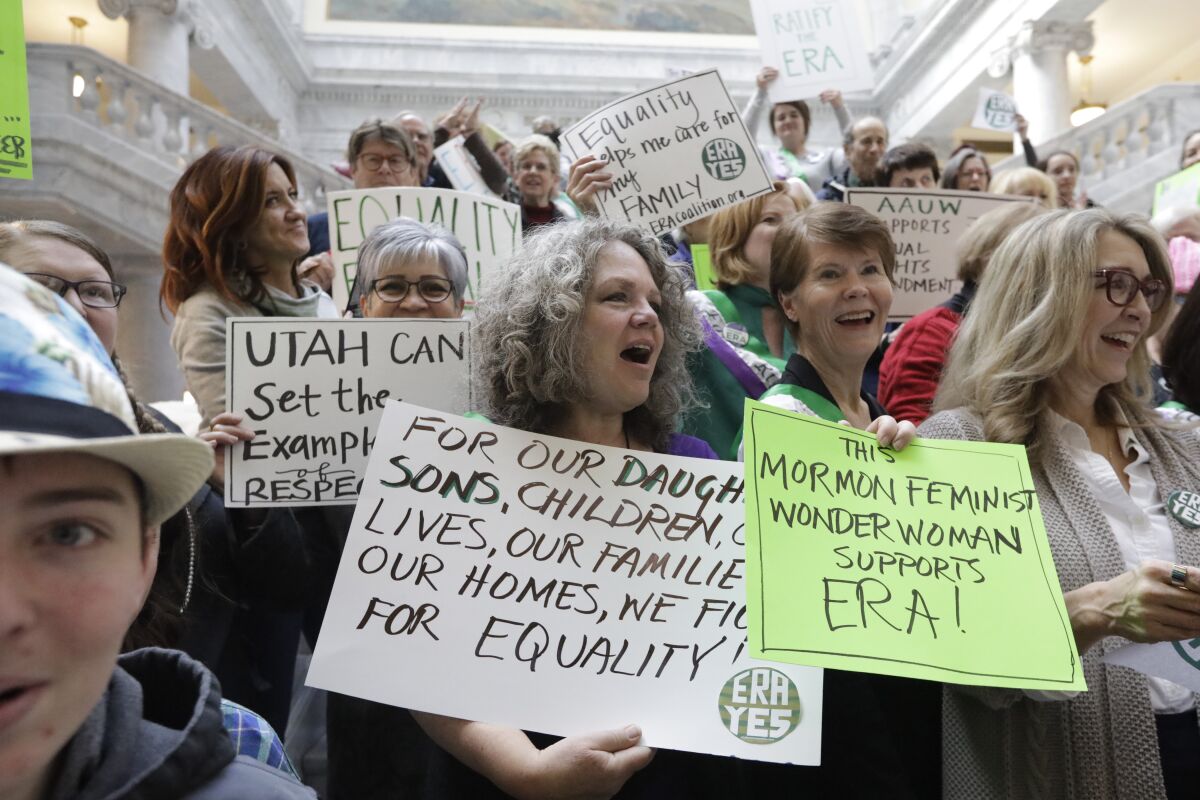 This Tuesday, Dec. 3, 2019, photo, supporters of the Equal Rights Amendment as they rally at the Utah State Capitol, in Salt Lake City. The renewed national push to ratify the Equal Rights Amendment is coming to conservative Utah, where supporters are launching a long-shot bid to challenge Virginia in becoming a potential tipping point despite opposition from the influential Church of Jesus Christ of Latter-day Saints. (AP Photo/Rick Bowmer)