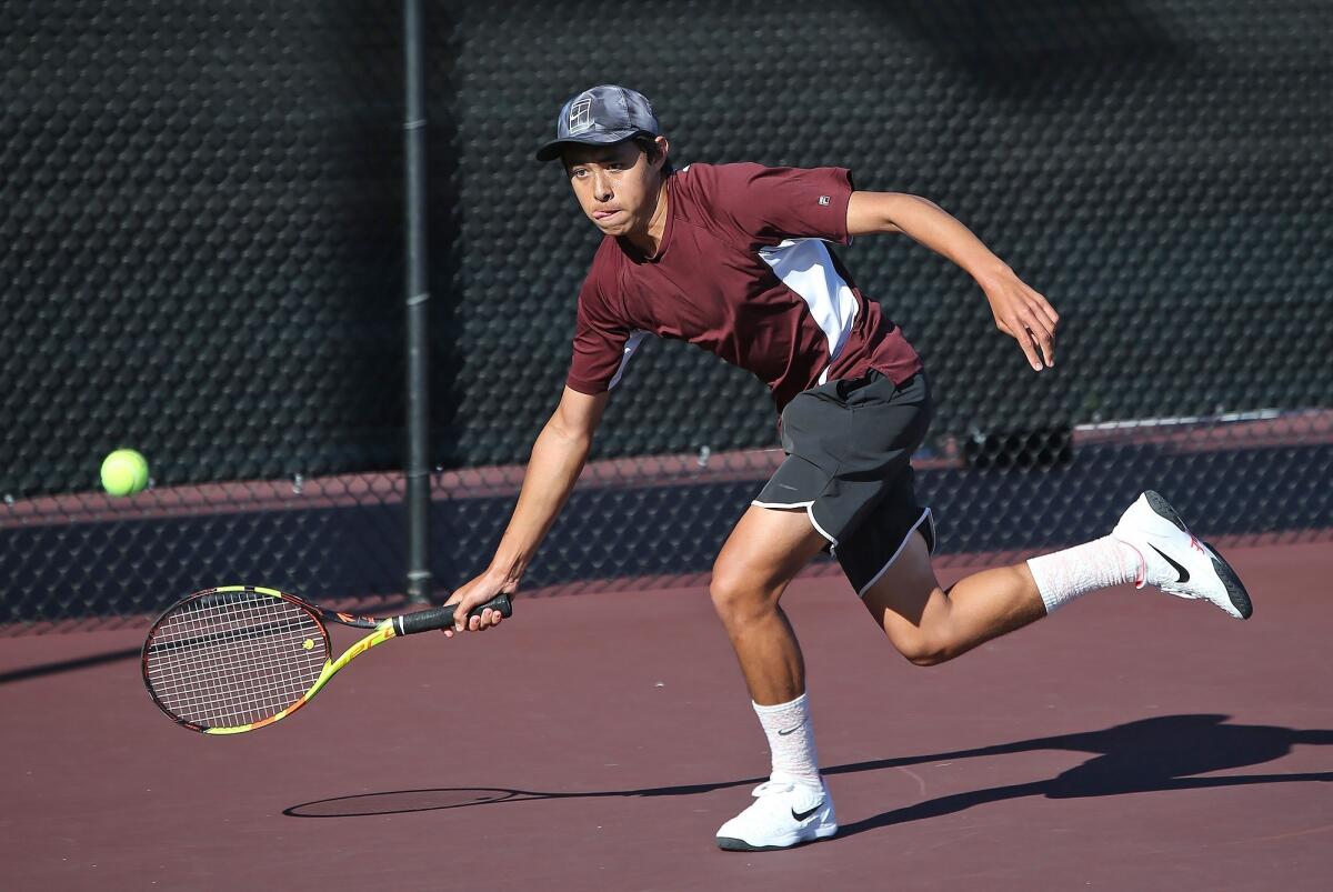 Laguna Beach High No. 1 singles player Mason Lebby runs down a forehand in a Wave League opener Thursday.