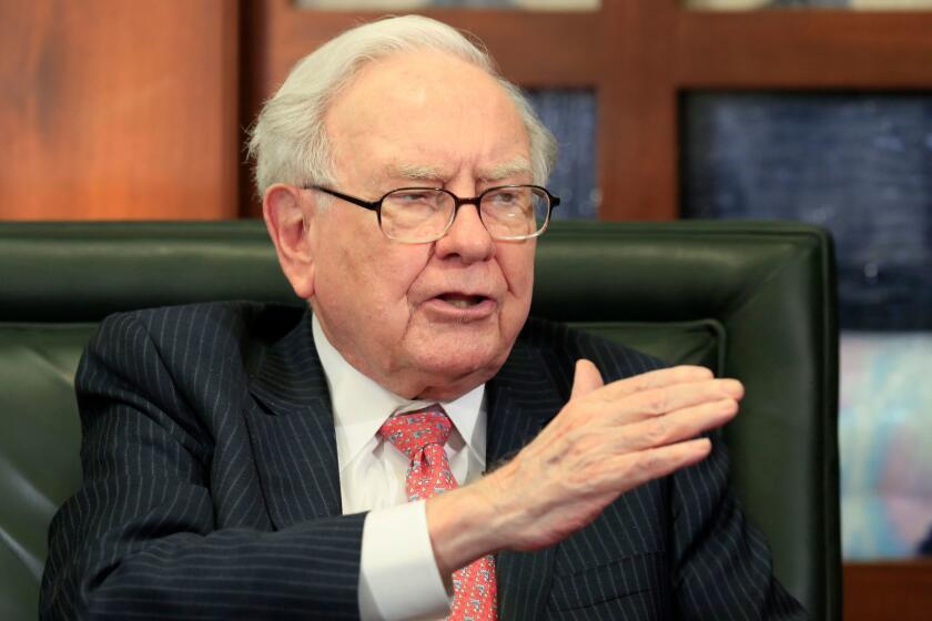 FILE - In a Monday, May 8, 2017, file photo, Berkshire Hathaway Chairman and CEO Warren Buffett speaks during an interview at the Fox Business Network in Omaha, Neb. Sempra Energy is buying Texas power transmitter Oncor for $9.45 billion in cash, wresting it away from Buffettâs Berkshire Hathaway. Sempra said Monday, Aug. 21, that it will also pick up $9.35 billion of the companyâs debt. (AP Photo/Nati Harnik, File)
