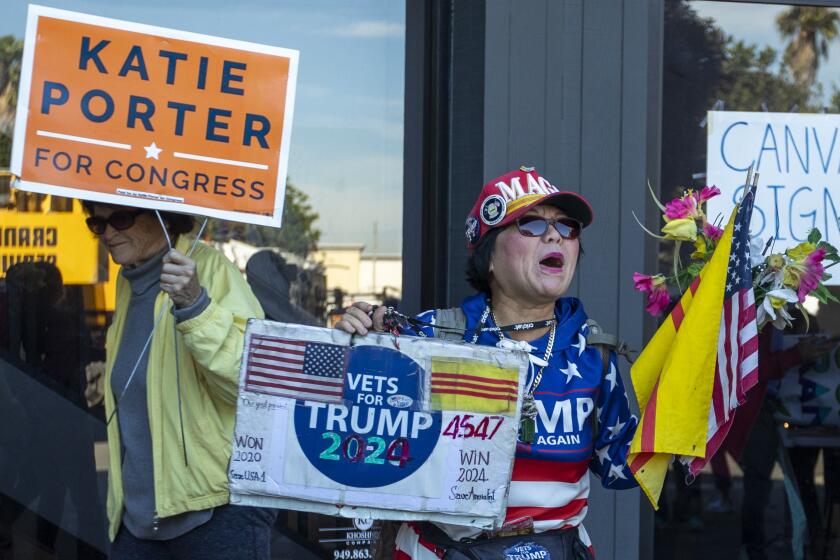  Victoria Cooper, right, yells as supporters depart a brief Katie Porter's rally on Nov. 5 in Huntington Beach, CA. 