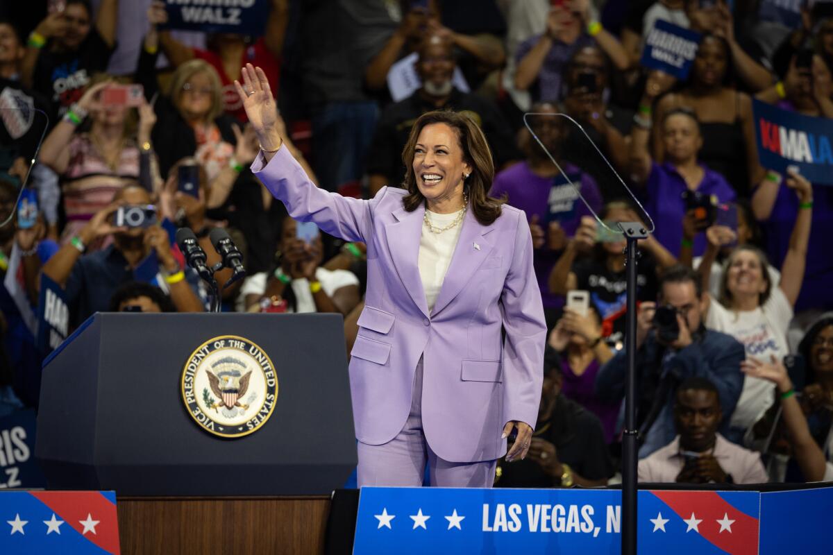 A woman raises her right arm.