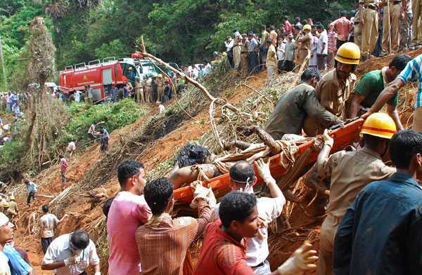 Rescue personnel recover a body from the crash site of an Air India Boeing 737-800 aircraft in Mangalore on May 22, 2010. An Air India Express passenger plane crashed in flames after overshooting the runway in the southern city of Mangalore, killing most of the 166 people on board. The state-run carrier said at least eight people had been rescued from the burning wreckage of the Boeing 737-800 which was carrying 160 passengers and six crew on a flight from Dubai.