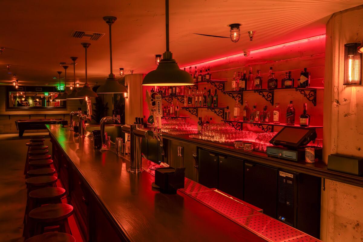 A bar interior with red lighting.