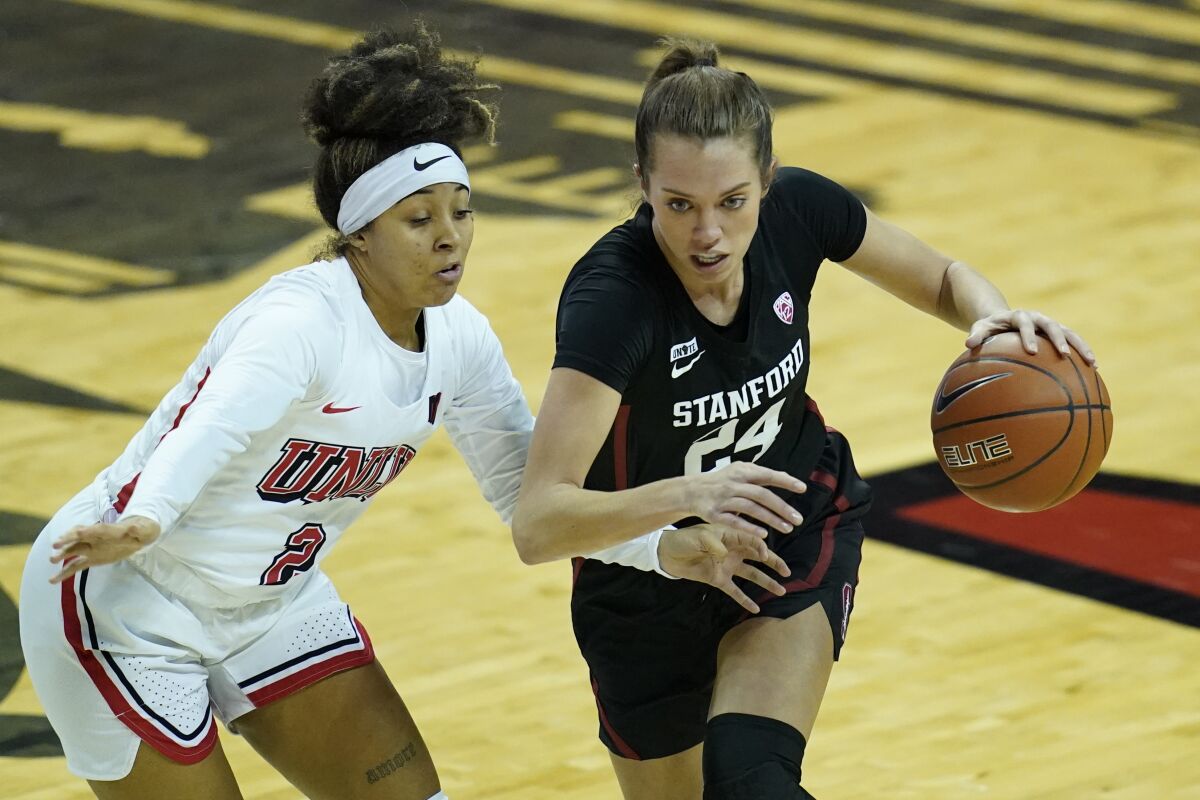 Stanford's Lacie Hull (24) drives around UNLV's Jasmine Singleton (2) during the second half of an NCAA college basketball game Saturday, Dec. 5, 2020, in Las Vegas. (AP Photo/John Locher)