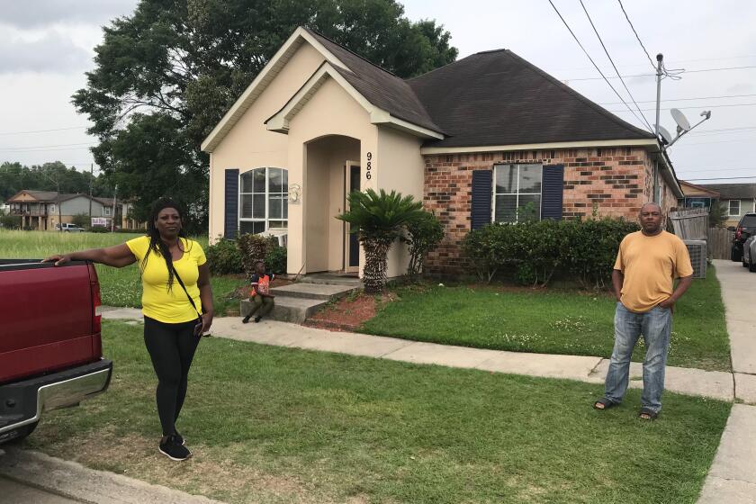 Tabby Granville (left) returned home to husband Kenneth Frazier and 6 year old son Kadien Frazier (right) in Baton Rouge Tuesday after taking her 79 year old father to the hospital where he tested positive for COVID-19. Photo by Molly Hennessy-Fiske (edited)