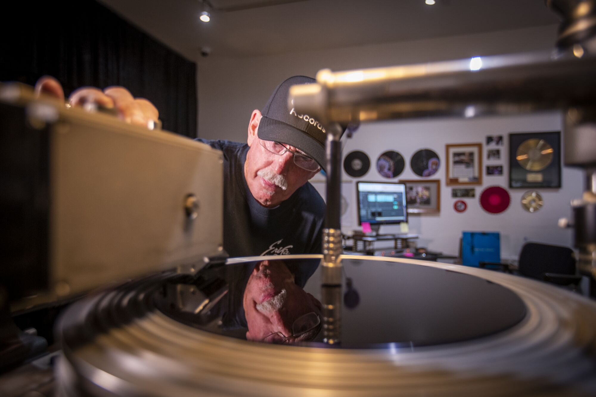 A man makes a vinyl LP at Erika Records.