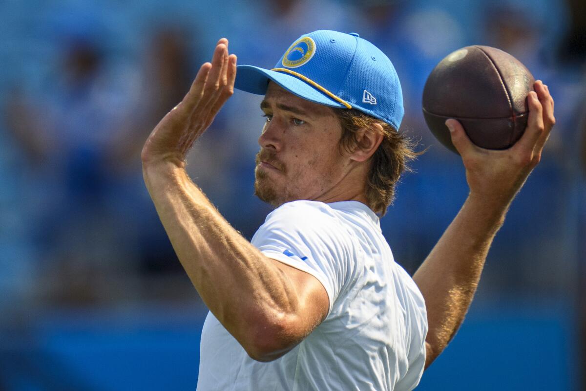 Chargers quarterback Justin Herbert (10) sets to throw the football during warm-ups.