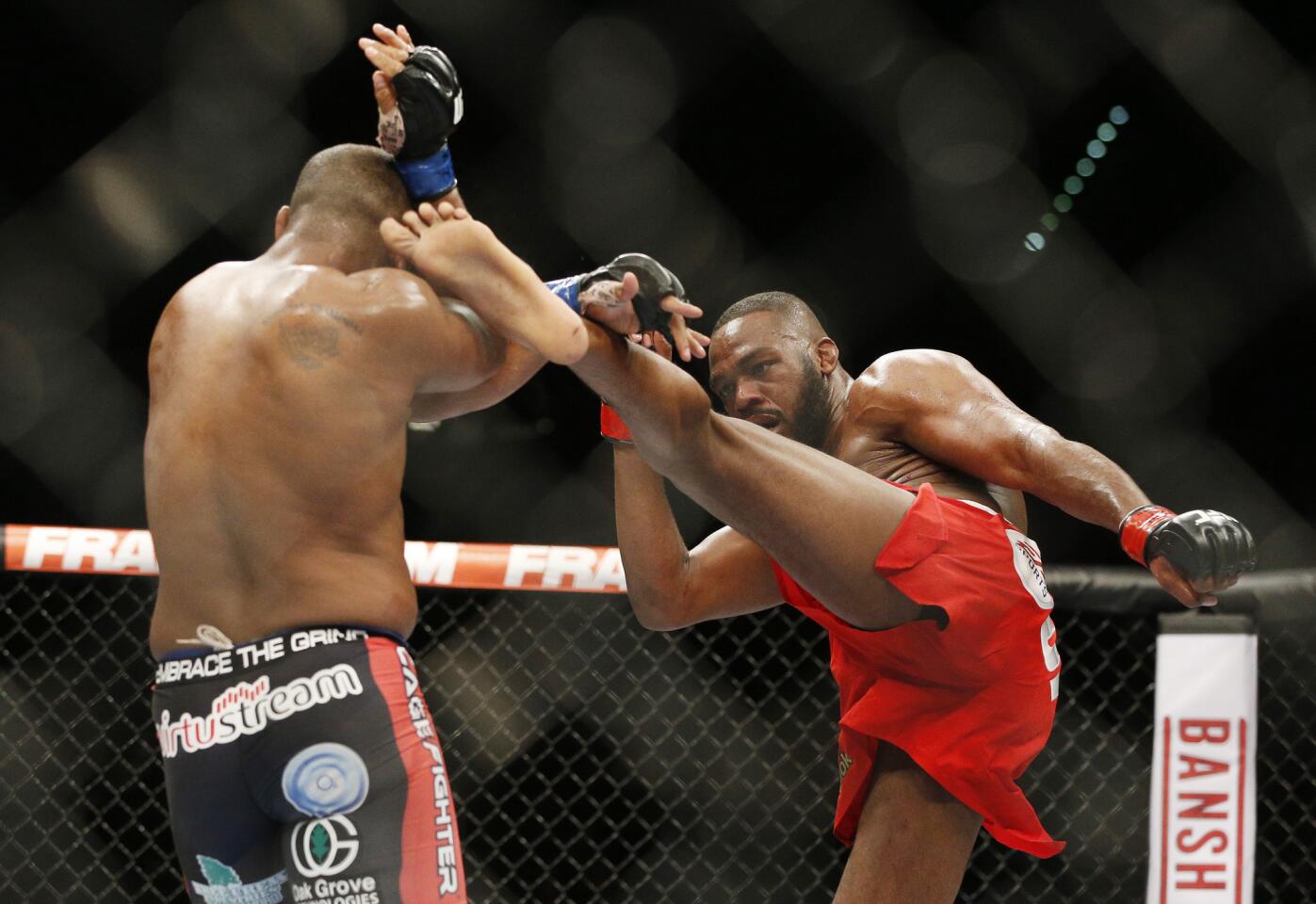 Daniel Cormier tries to block a kick by Jon Jones during their light-heavyweight championship fight at the MGM Grand Garden Arena.