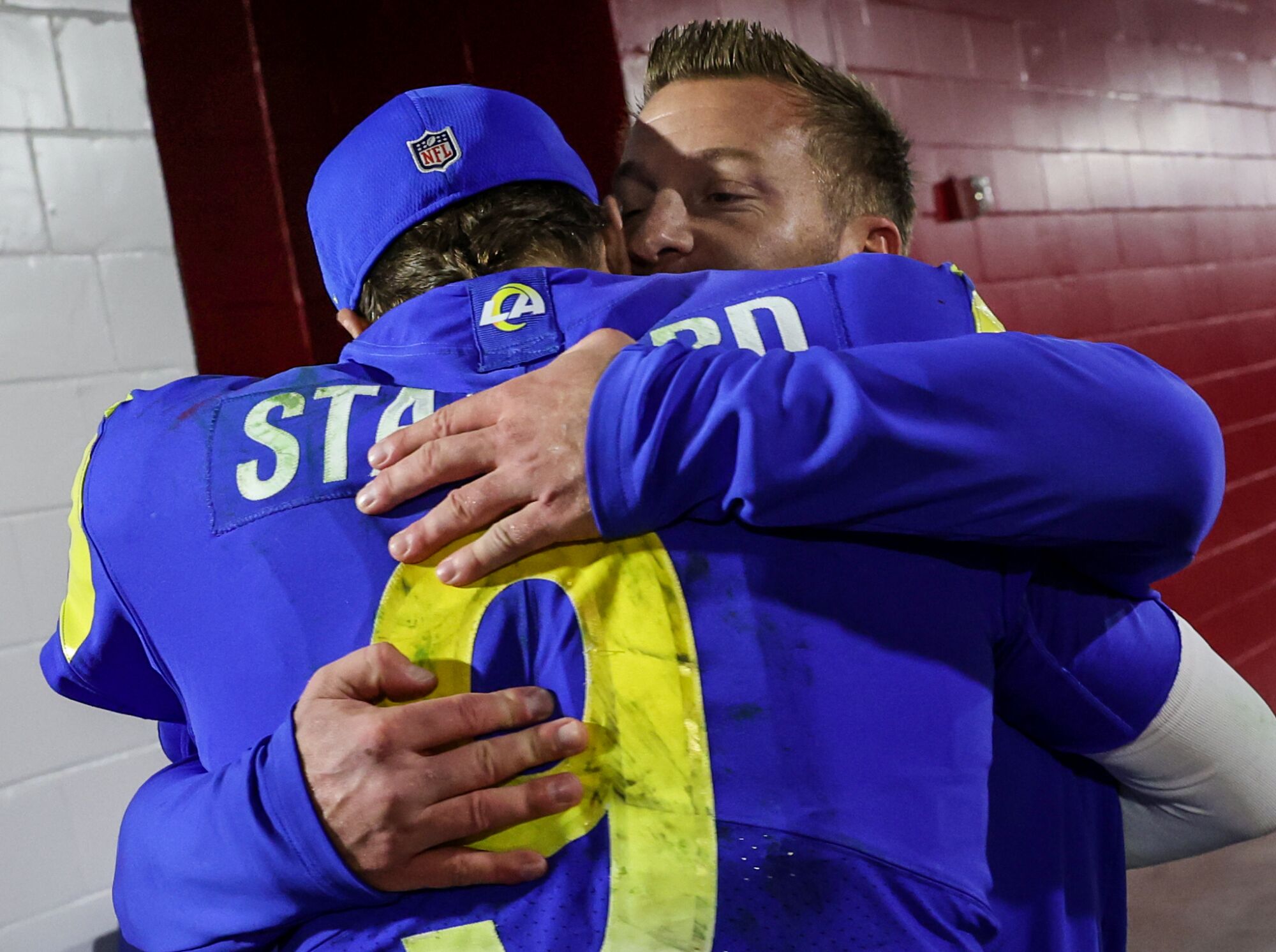 Rams coach Sean McVay rushes to hug quarterback Matthew Stafford.