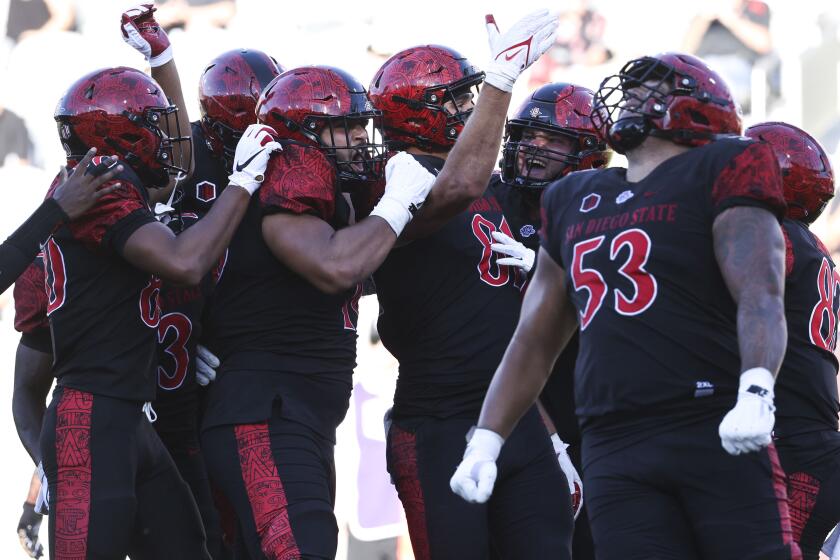 San Diego, CA - August 26: San Diego State Aztecs players celebrate a touchdown against the Ohio Bobcats during their game at Snapdragon Stadium on Saturday, Aug. 26, 2023 in San Diego, CA. (Meg McLaughlin / The San Diego Union-Tribune)