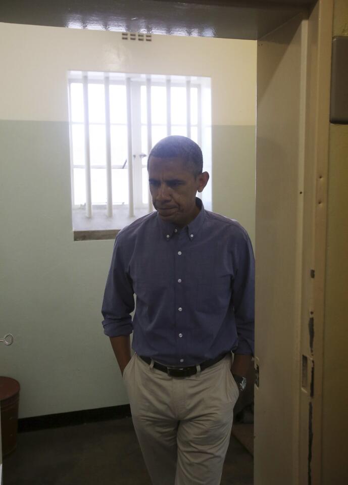 U.S. President Obama leaves the Robben Island prison cell that Nelson Mandela spent 18 of his 27 years of imprisonment near Capetown