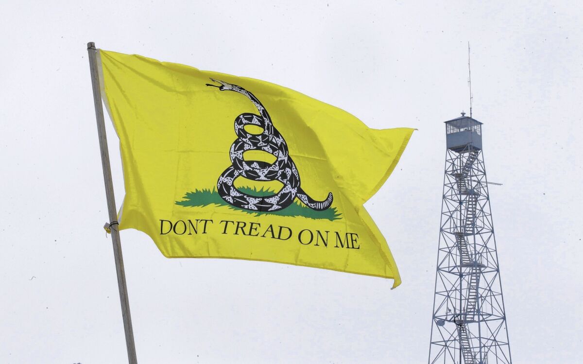 The Gadsden flag flies at the entrance of the Malheur National Wildlife Refuge, near Burns, Ore. An armed group has been occupying the refuge since Jan. 2.