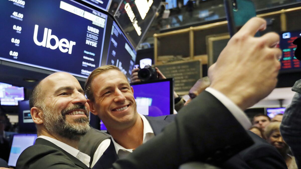 Uber CEO Dara Khosrowshahi, left, and board member Ryan Graves on Friday at the New York Stock Exchange.