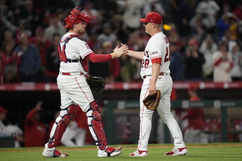 Los Angeles Angels catcher Chad Wallach (35) and relief pitcher Aaron Loup (28) celebrate after a 7-3 win over the Boston Red Sox in a baseball game in Anaheim, Calif., Wednesday, May 24, 2023. (AP Photo/Ashley Landis)
