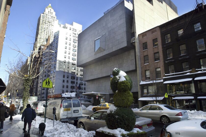 FILE — The Whitney Museum of American Art, center, is shown on New York's Madison Avenue, Jan. 25, 2005. The auction house Sotheby's will buy the modernist Marcel Breuer-designed building that housed New York's Whitney Museum of American Art for nearly 50 years, Sotheby's announced Thursday, June 1, 2023. (AP Photo/Bebeto Matthews, File)
