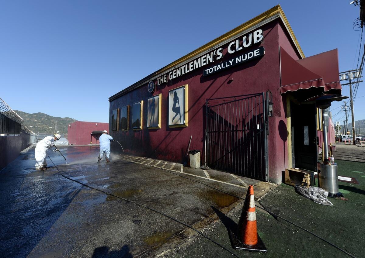 Workers clean up crude oil that spilled after a pipeline leaked in Atwater Village.