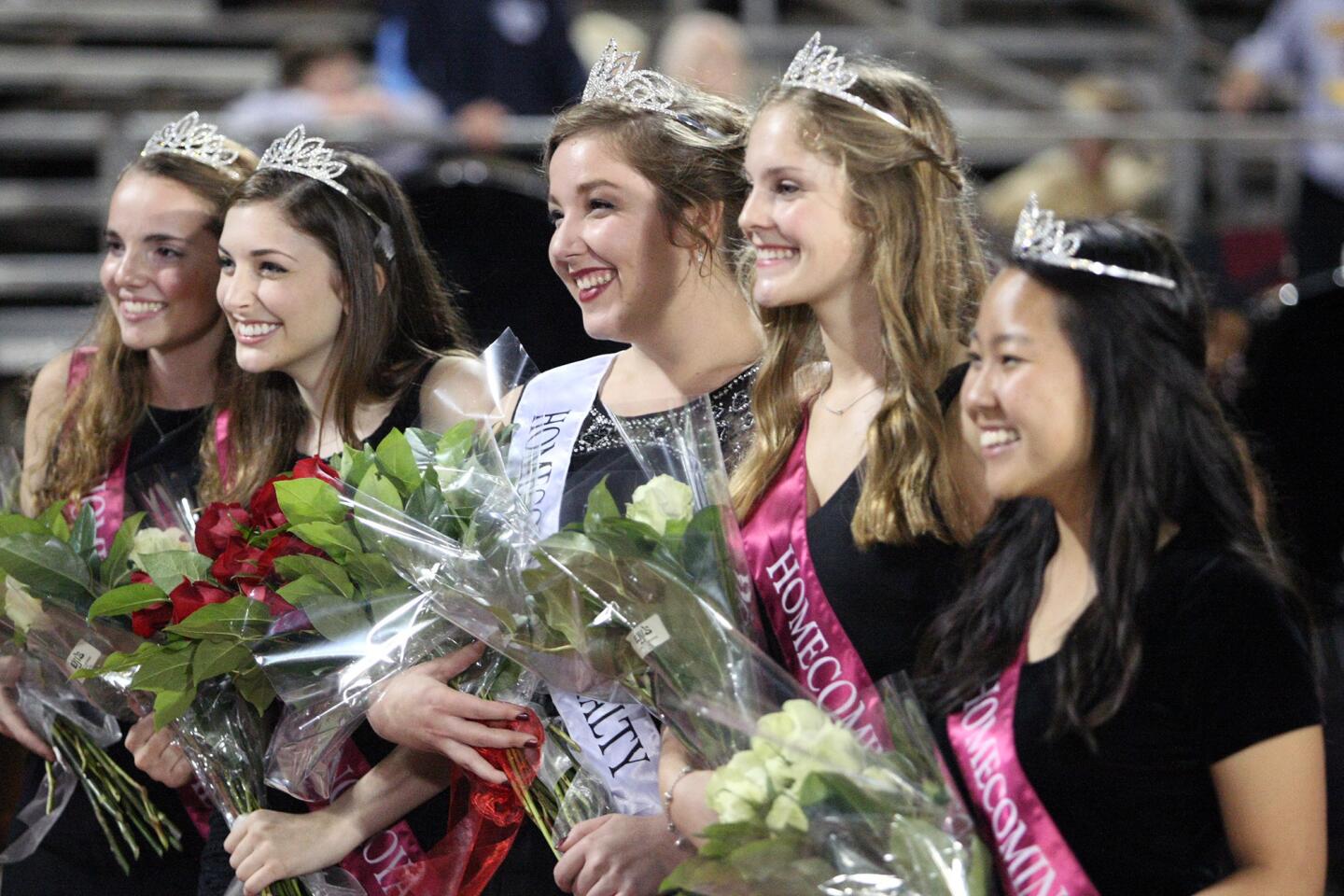 The homecoming court poses for photos during halftime at the La Cañada High School football game on Friday, Oct. 16, 2015.