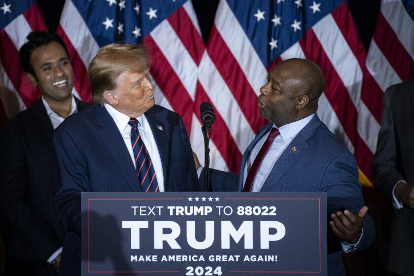Senator Tim Scott, a Republican from South Carolina, right, and former US President Donald Trump during a New Hampshire primary election night watch party in Nashua, New Hampshire, US, on Tuesday, Jan. 23, 2024. Trump won the New Hampshire primary, dealing a blow to his only remaining major rival Nikki Haley and solidifying his status as the Republican party's likely nominee. Photographer: Al Drago/Bloomberg via Getty Images
