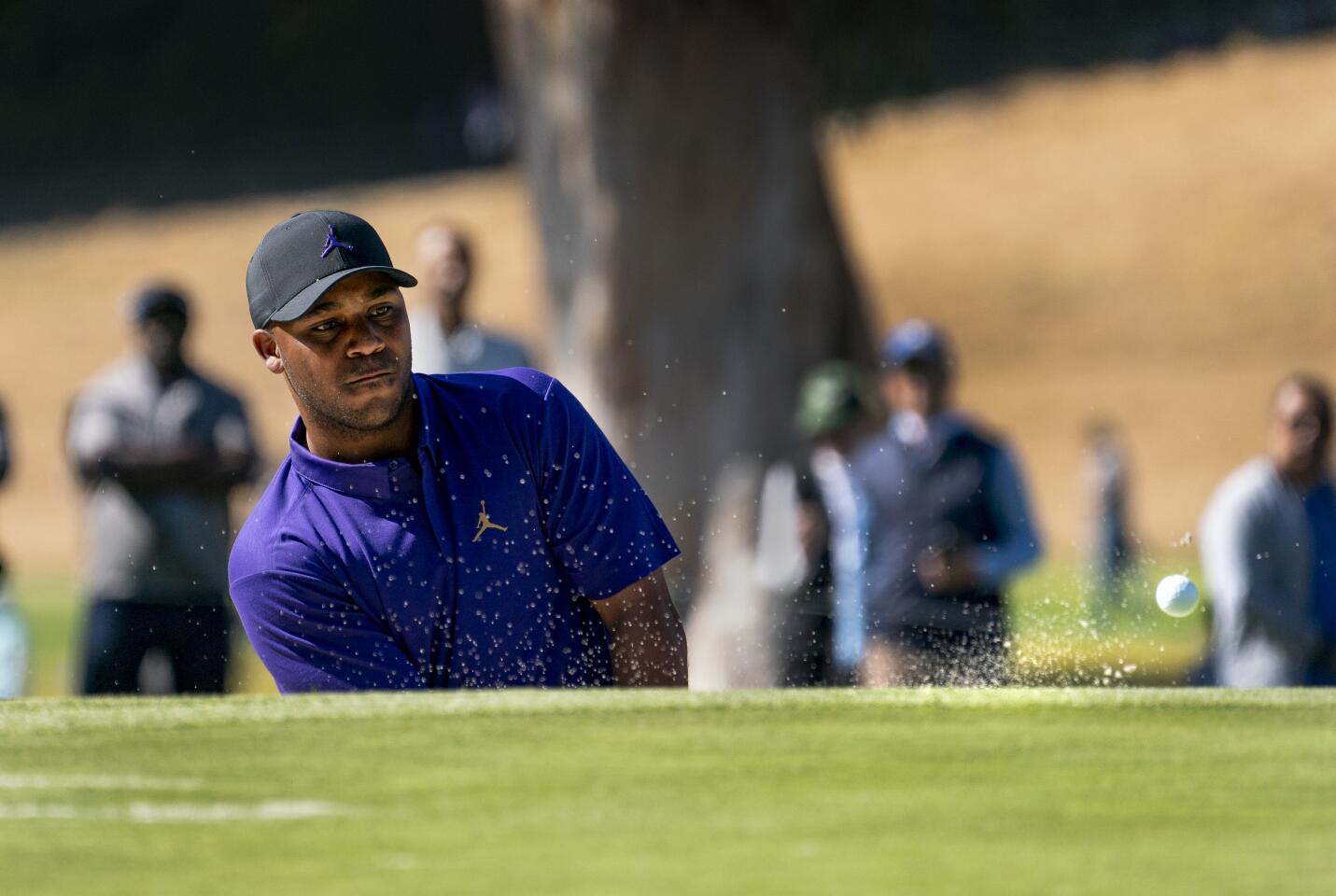 Harold Varner III hits out of a bunker and onto the 10th hole green during the final round of the Genesis Invitational at Riviera Country Club on Feb. 16, 2020.