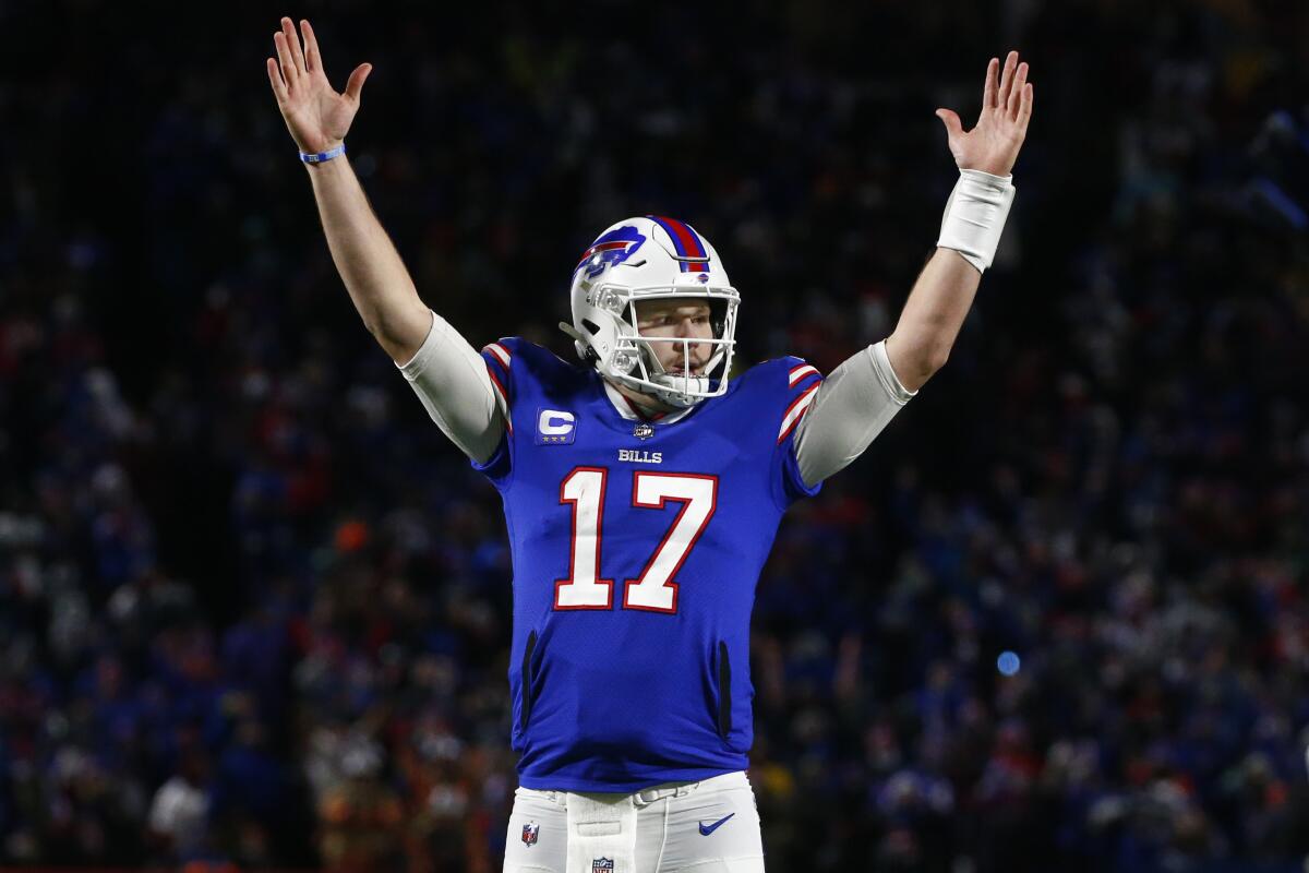 Buffalo Bills quarterback Josh Allen raises his arms to celebrate a touchdown