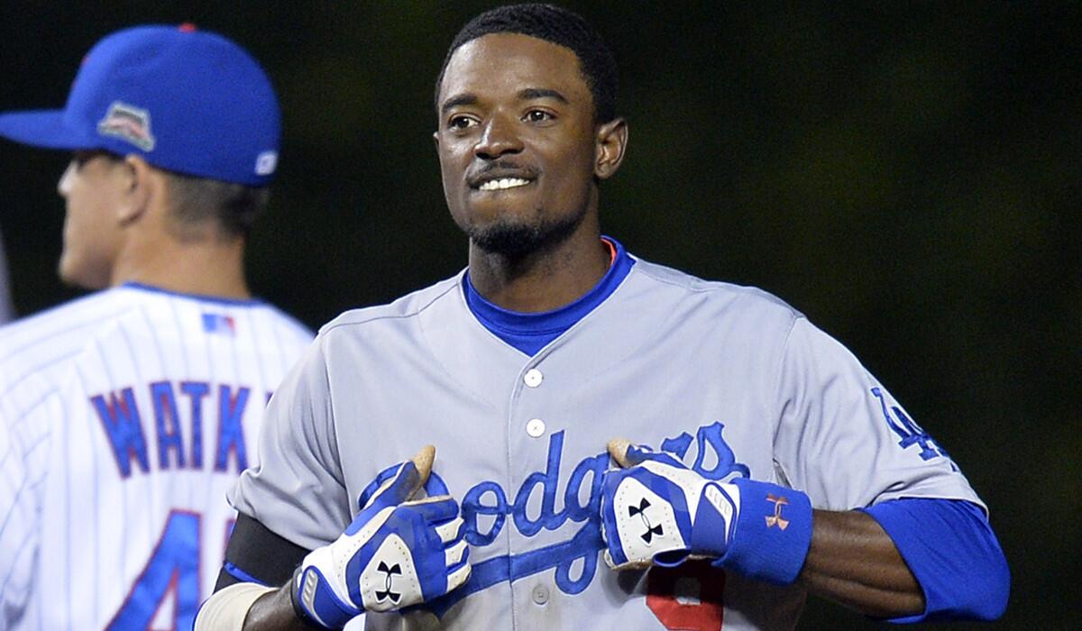 Dodgers second baseman Dee Gordon reacts after hitting a run-scoring double against the Cubs last month in Chicago.