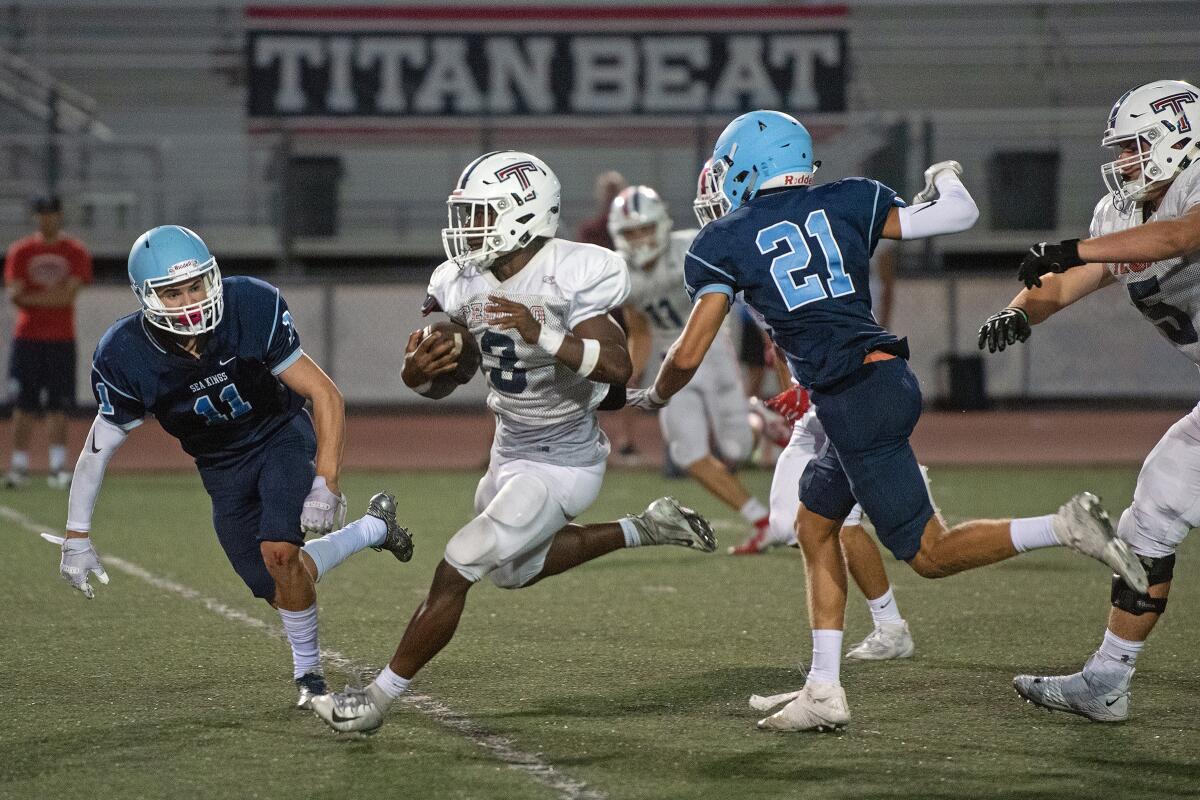 Tesoro running back Zach Wran breaks through the Corona del Mar defense to record one of his two long touchdown runs in Friday's scrimmage.