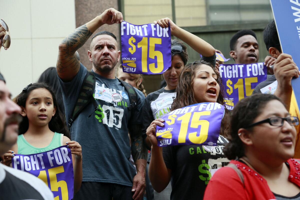 Workers last July rally in Los Angeles in support of raising the minimum wage.