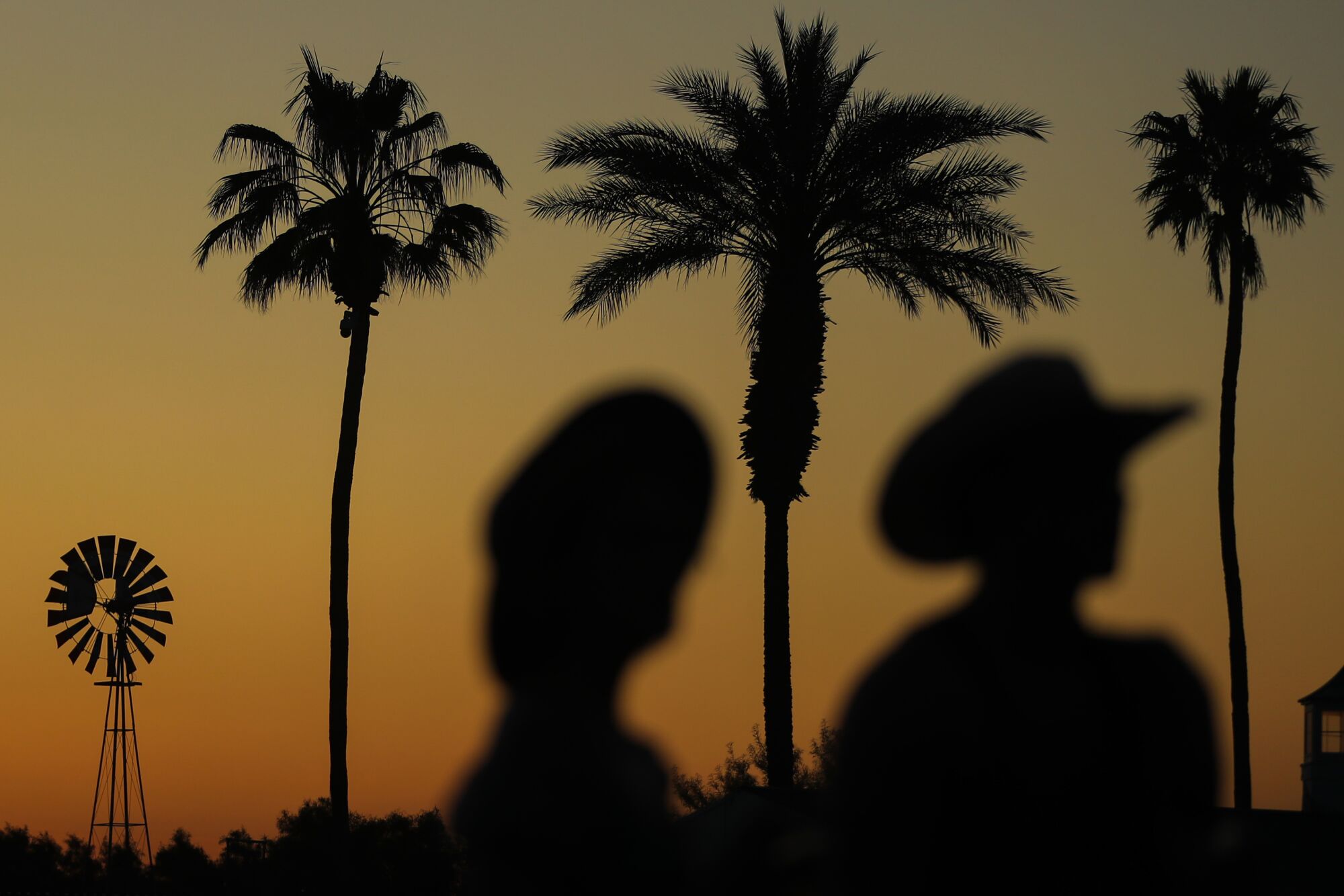 The sunset lights up the sky with an orange glow as fans watch Melissa Etheridge on the first day of Stagecoach.