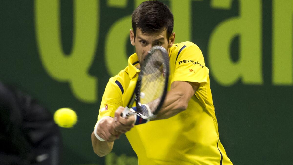 Novak Djokovic returns a shot against Rafael Nadal during the Qatar Open final on Saturday.