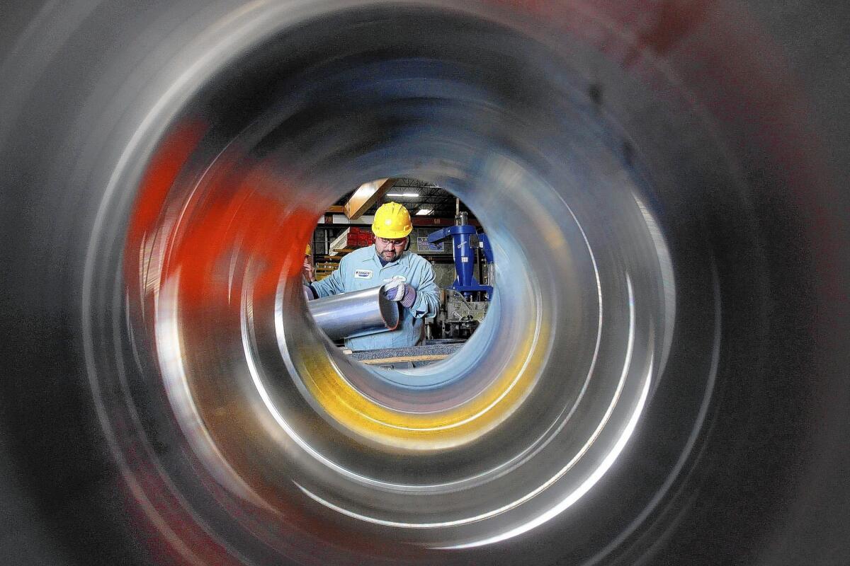 The U.S. energy boom has boosted demand for steel tubes. Above, a view through tubing used in parts at a Reliance Steel & Aluminum subsidiary.