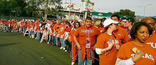 Texas Longhorns fans line-up to see their team arrive before the start of the BCS National Championship Rose Bowl Game against the USC Trojans.