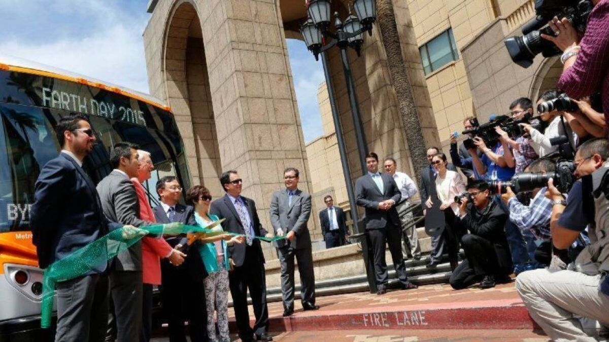 BYD and then-Supervisor Mike Antonovich, third from left, unveil the first five electric buses delivered to Metro in 2015. Instead of going into service, the buses were sent back to BYD for "extensive" reworking.