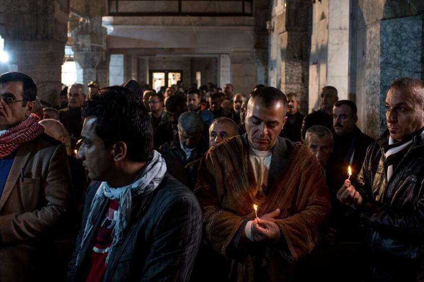 Iraqis attend Christmas Mass at the Mar Shimoni church in Bartella, a predominantly Christian town recently recaptured from Islamic State.