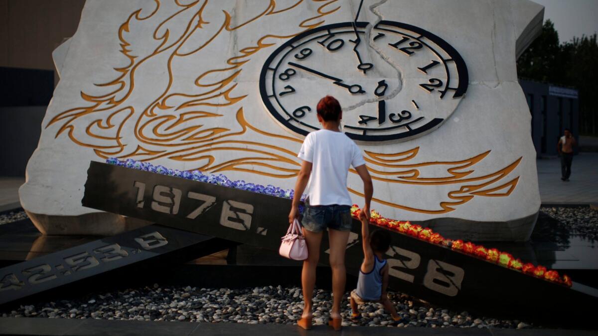 Success in predicting a 1975 earthquake in China was shortlived. In 1976, scientists did not predict a magnitude 7.6 earthquake that killed a quarter-million people. Visitors stop at a memorial to the dead in 2016. (European Pressphoto Agency)
