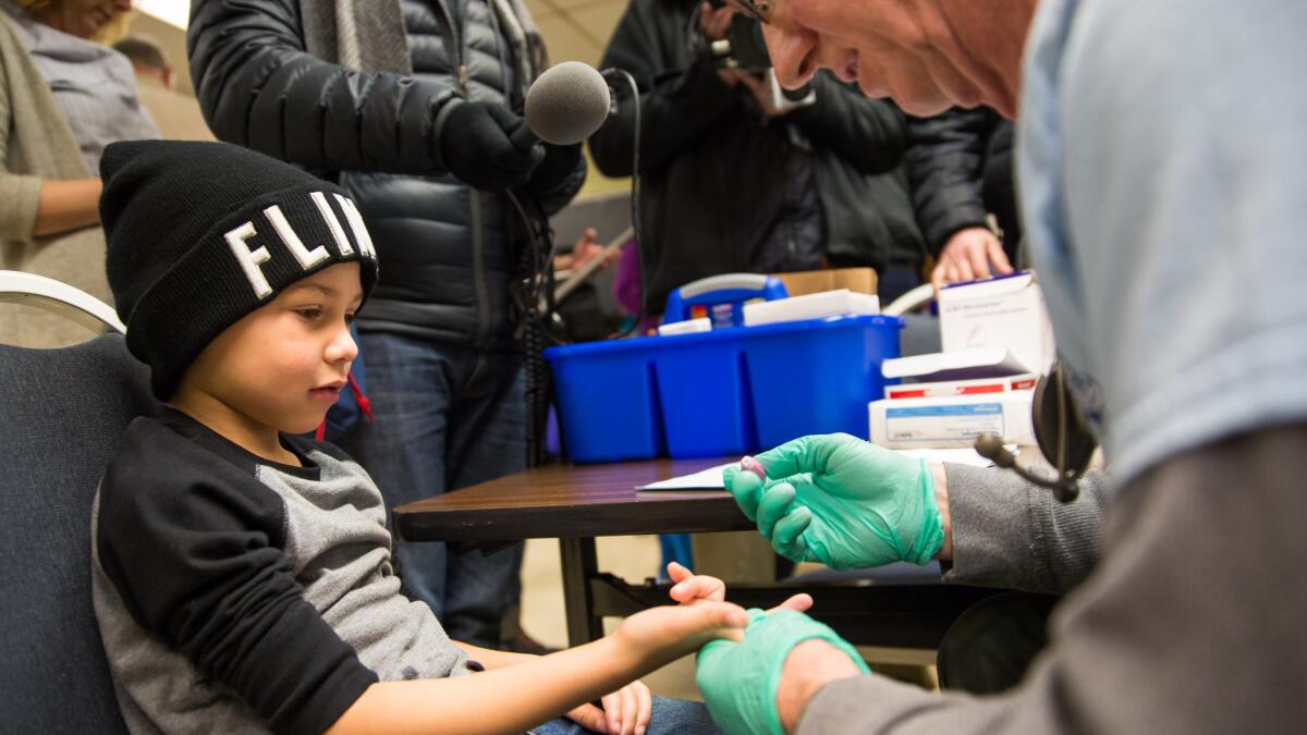 Grayling Stefek has his blood drawn as part of a lead screening campaign in Flint, Mich., in January.