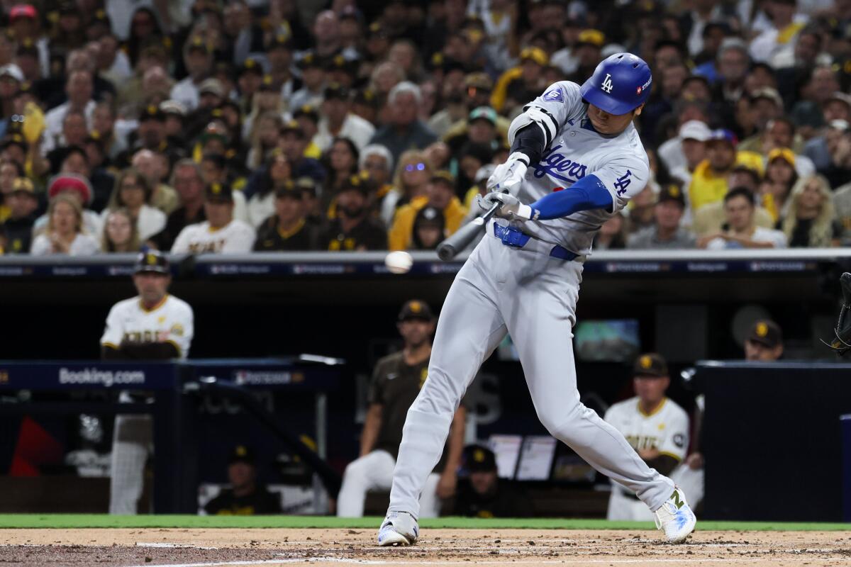 Dodgers star Shohei Ohtani hits a run-scoring single against the San Diego Padres in Game 4 of the NLDS Oct. 9.