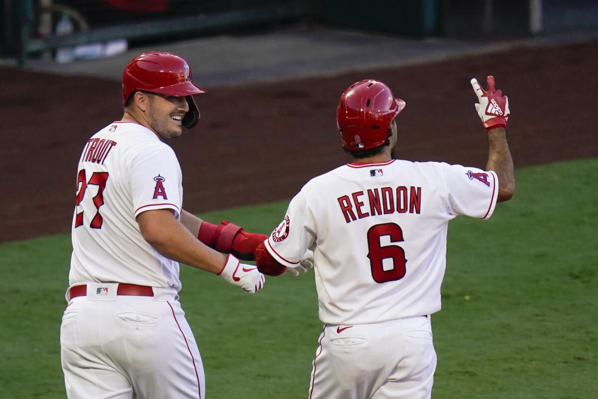Los Angeles Angels' Anthony Rendon, right, celebrates his two-run home run with Mike Trout.