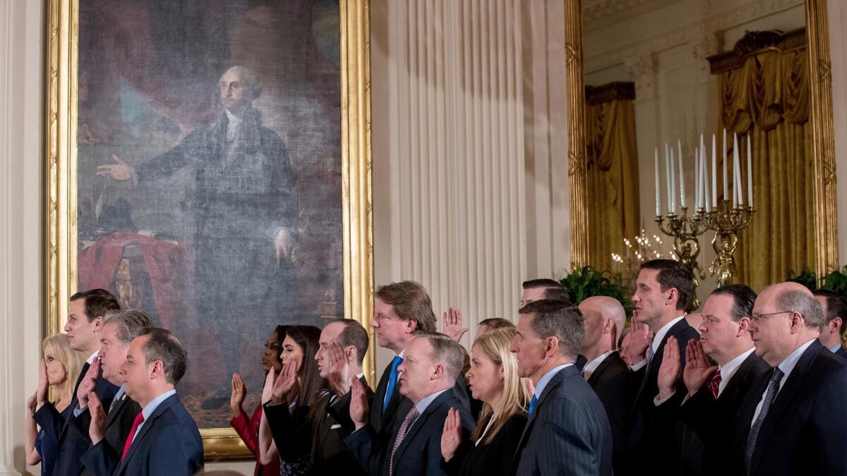 Advisors to President Trump swear an oath of service Sunday in the White House. In the front row are Kellyanne Conway, left, Jared Kushner, Stephen Bannon and Chief of Staff Reince Priebus.